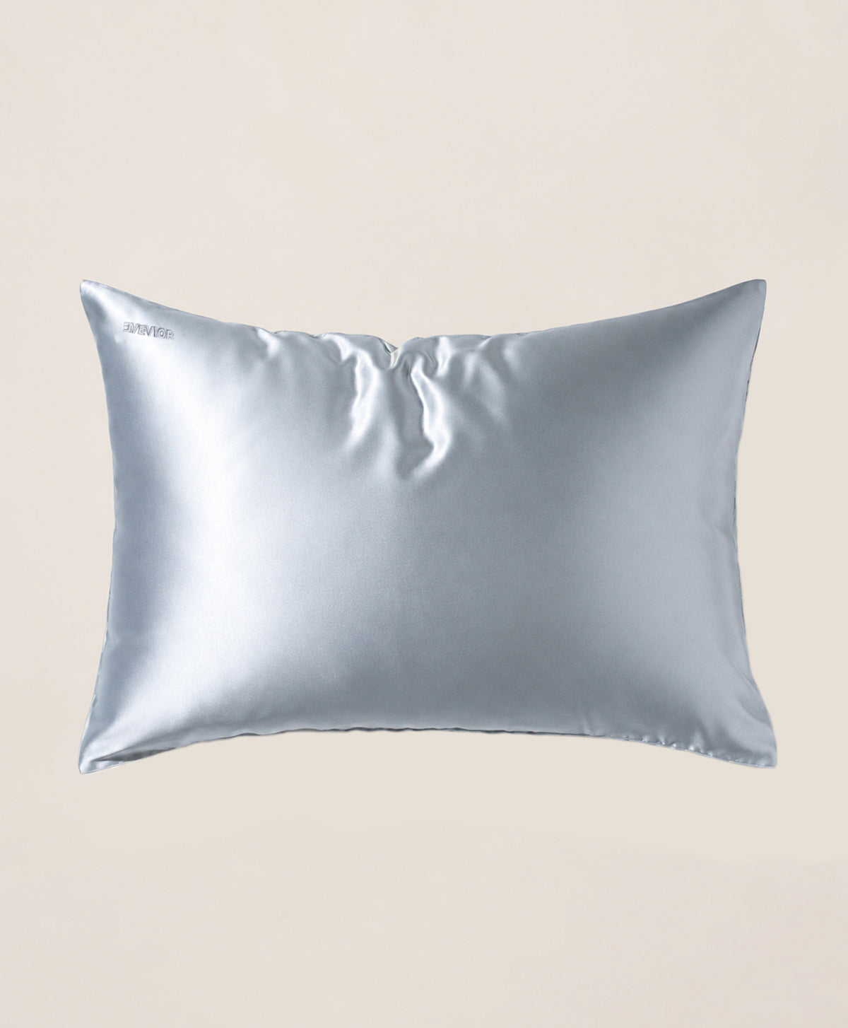 A pillow covered in a light blue silk pillowcase with a subtle sheen, shown against a solid beige background.