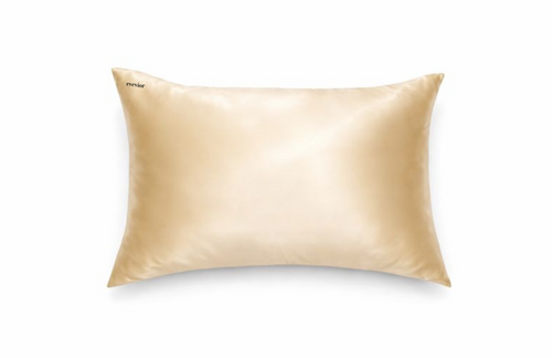Champagne silk pillowcase with small black embroidered logo in the top left corner.
