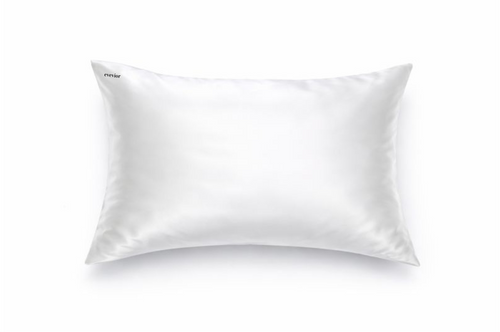 Pearl white silk pillowcase with small black embroidered logo in the top right corner.