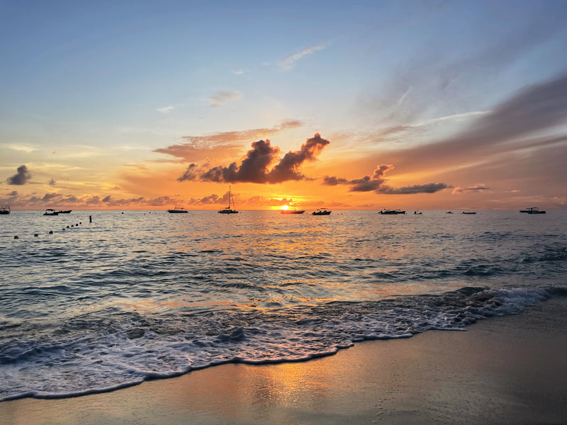 Sunset over the ocean at Heywoods Beach with boats.